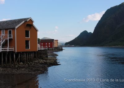 typical Scandinavian red wooden houses along a river, Mosjøen, Norway